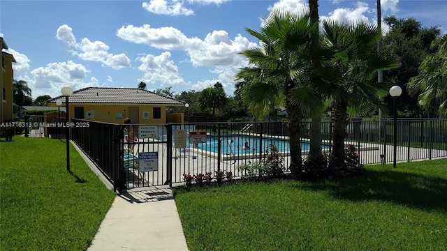 view of swimming pool featuring a lawn