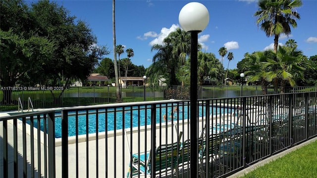 view of swimming pool with a water view