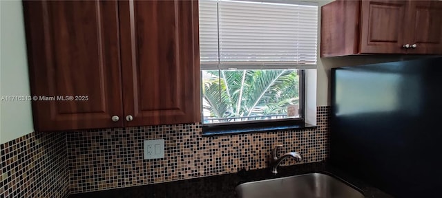 kitchen featuring sink and tasteful backsplash