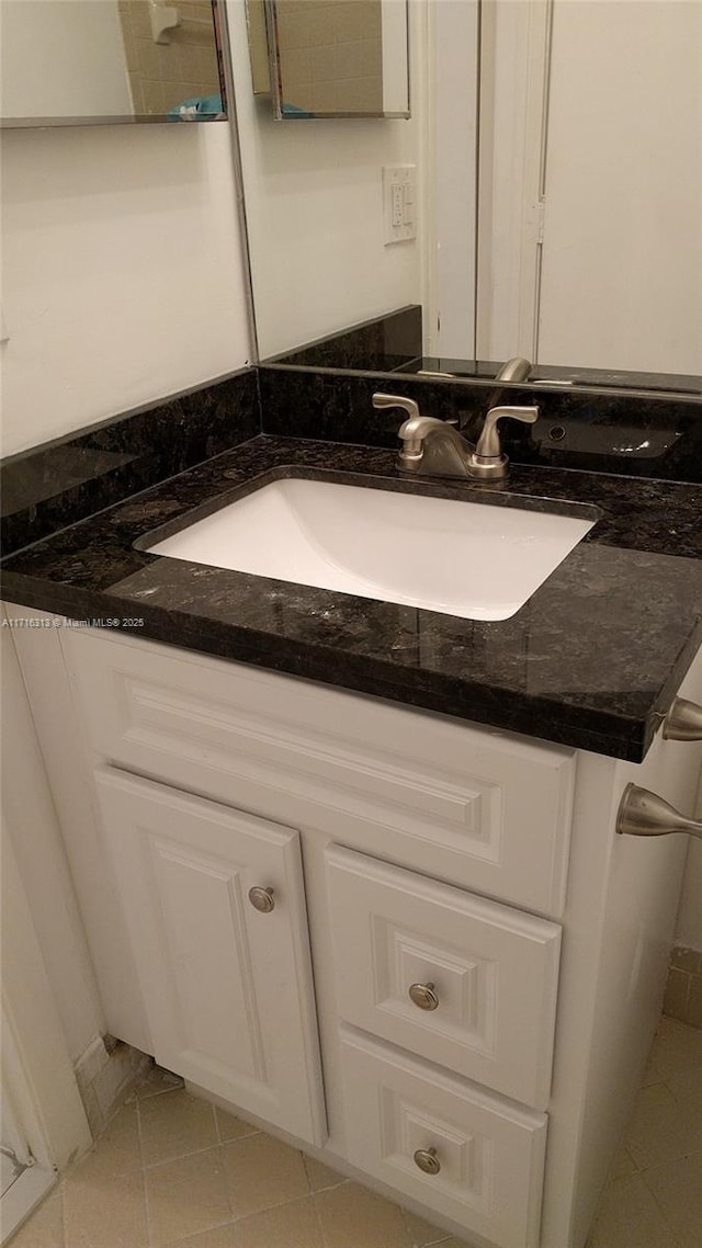 bathroom featuring tile patterned flooring and vanity