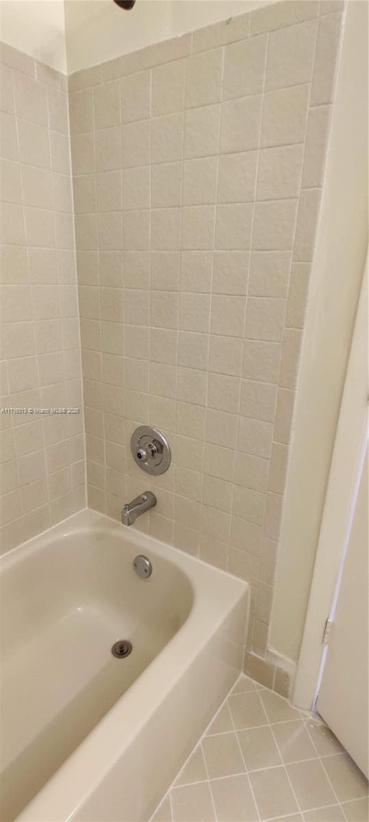 bathroom with tile patterned flooring and shower / bathing tub combination