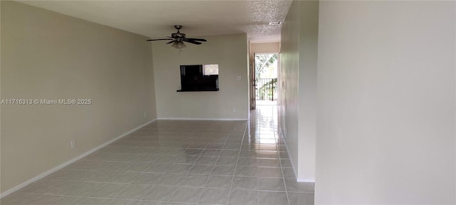 hall featuring light tile patterned floors and a textured ceiling