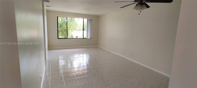 spare room with a textured ceiling, ceiling fan, and light tile patterned flooring