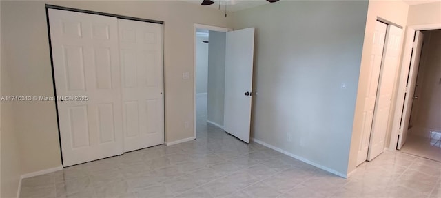 unfurnished bedroom featuring ceiling fan, light tile patterned flooring, and a closet