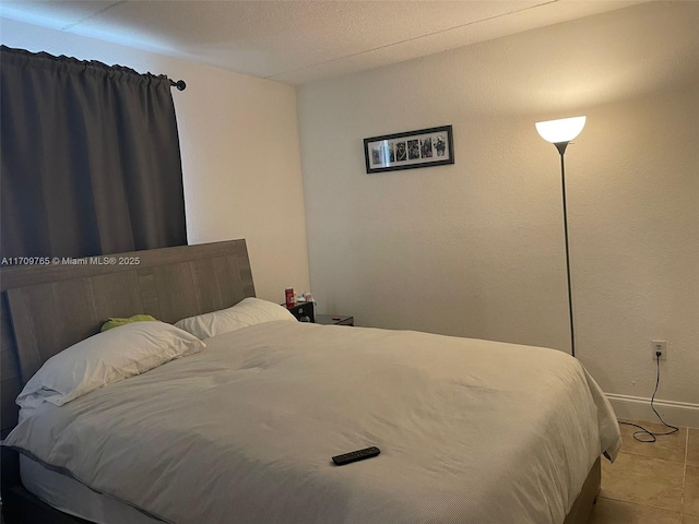 bedroom featuring light tile patterned floors