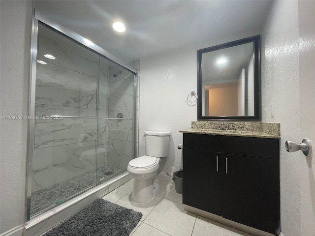 bathroom with vanity, toilet, walk in shower, and tile patterned floors