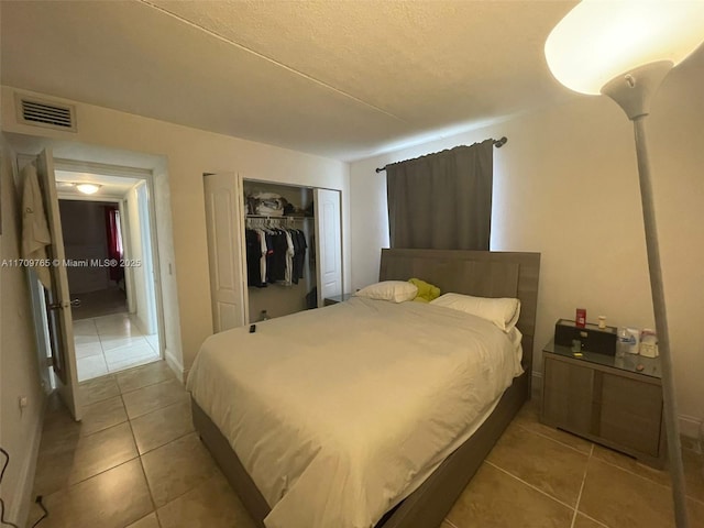 bedroom featuring a closet and tile patterned flooring