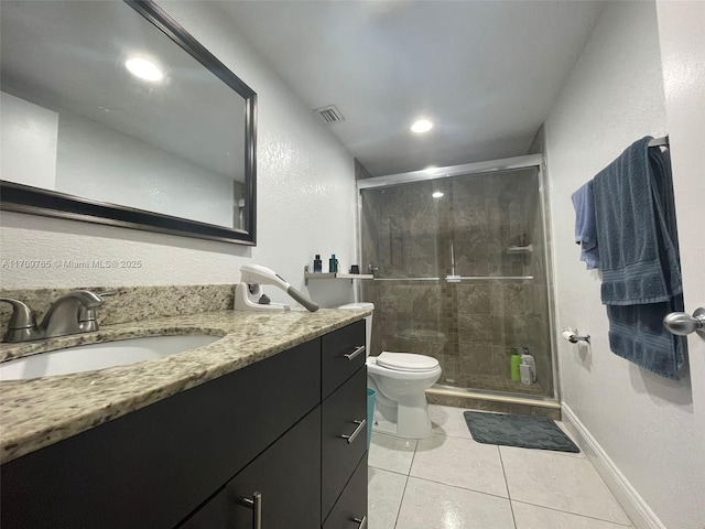 bathroom with an enclosed shower, tile patterned floors, vanity, and toilet