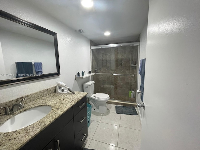 bathroom featuring an enclosed shower, tile patterned floors, vanity, and toilet