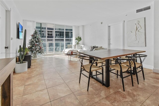 tiled dining area with floor to ceiling windows