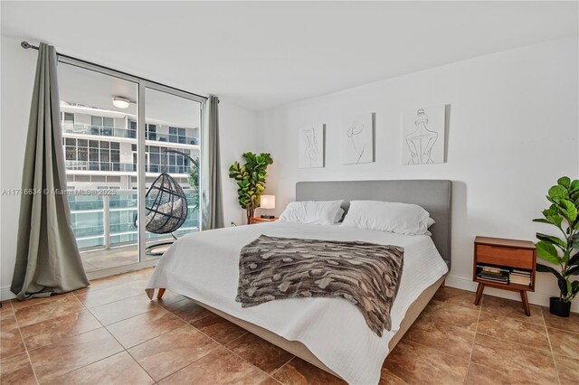 bedroom with a wall of windows and access to outside