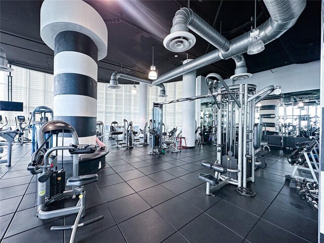 exercise room with a high ceiling