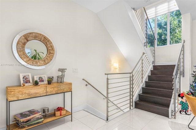 stairway with tile patterned floors