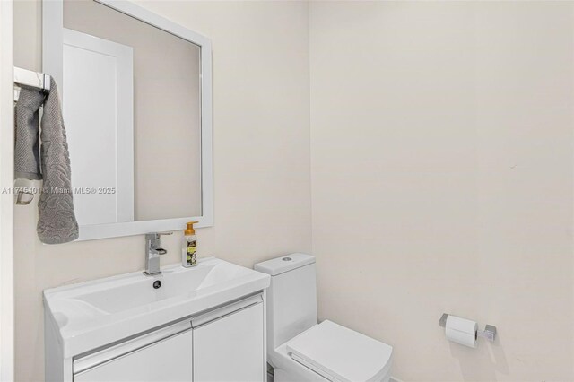 bathroom featuring vanity and toilet