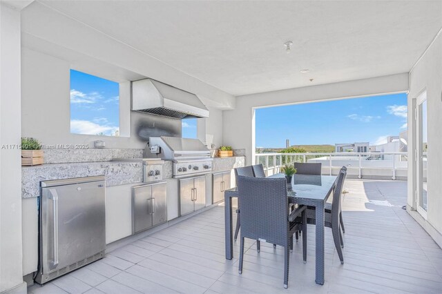 view of patio / terrace with an outdoor kitchen and a grill