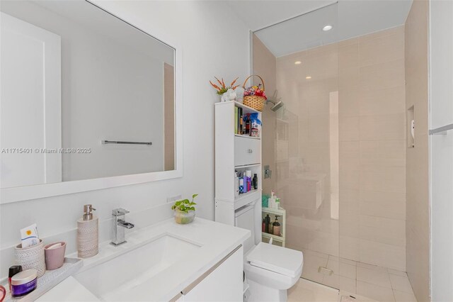 bathroom featuring a shower, vanity, and toilet