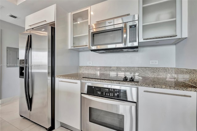 888 Biscayne Blvd Unit 411, Miami, FL 33132 - kitchen with appliances with stainless steel finishes, glass insert cabinets, white cabinetry, and light stone counters