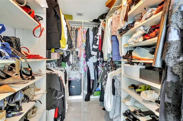 walk in closet with light tile patterned floors