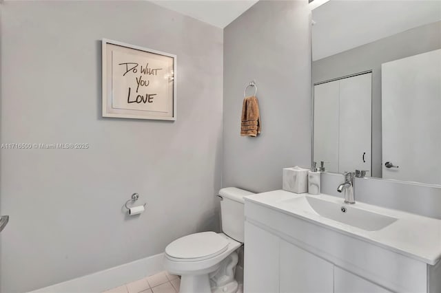 bathroom with tile patterned floors, vanity, and toilet