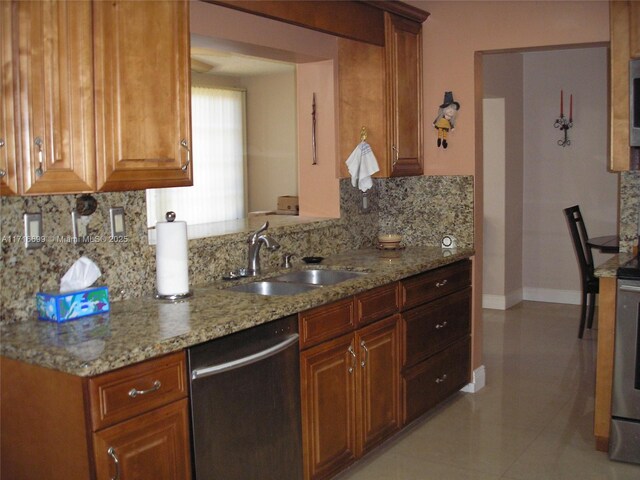 4723 NW 44th St, Tamarac, FL 33319 - kitchen featuring brown cabinetry, backsplash, appliances with stainless steel finishes, light stone countertops, and glass insert cabinets
