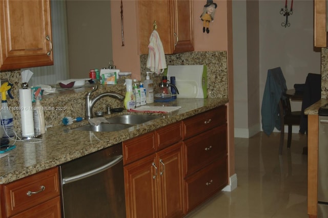 kitchen with tasteful backsplash, light stone counters, sink, and stainless steel dishwasher