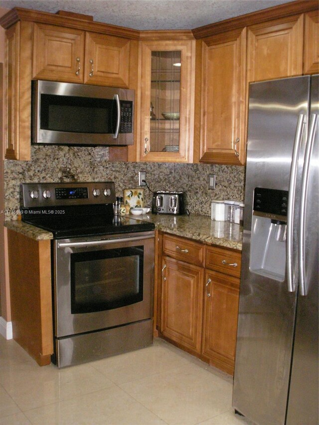 4723 NW 44th St, Tamarac, FL 33319 - kitchen featuring stainless steel dishwasher, light stone countertops, baseboards, a sink, and backsplash