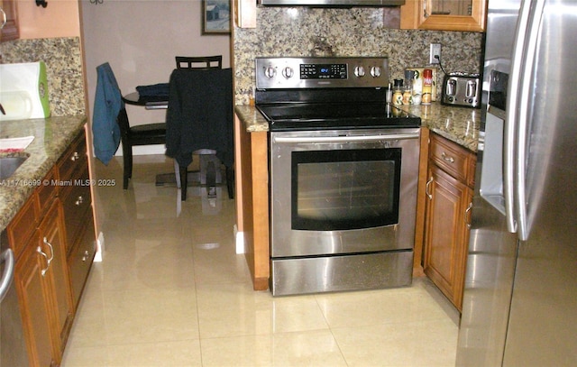 kitchen featuring light tile patterned floors, stainless steel appliances, stone counters, and tasteful backsplash