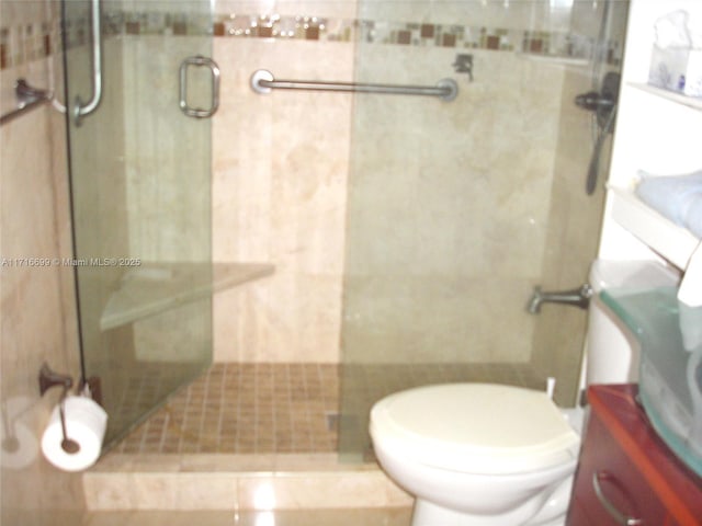 bathroom with tile patterned floors, toilet, and walk in shower