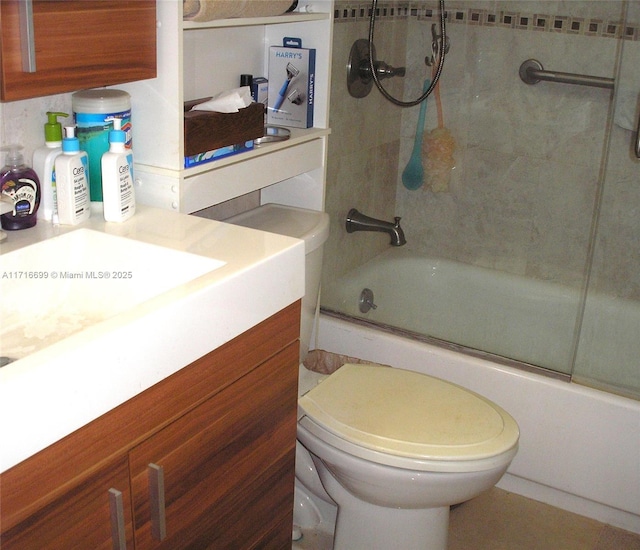 full bathroom with vanity, enclosed tub / shower combo, and toilet