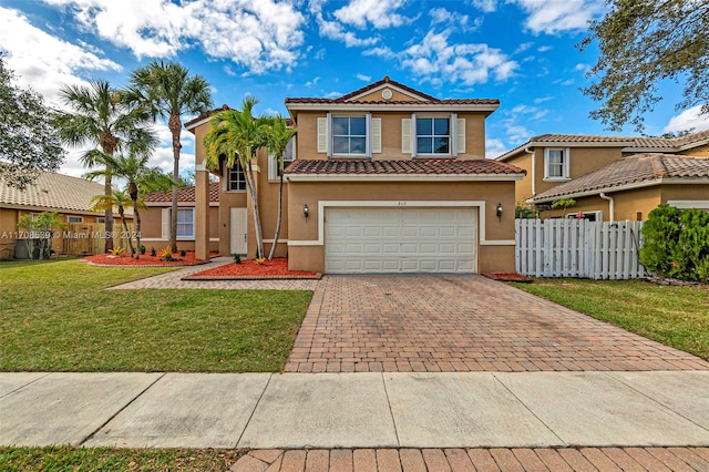 mediterranean / spanish-style home featuring a front lawn and a garage