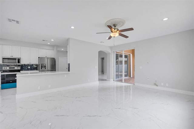 unfurnished living room with ceiling fan