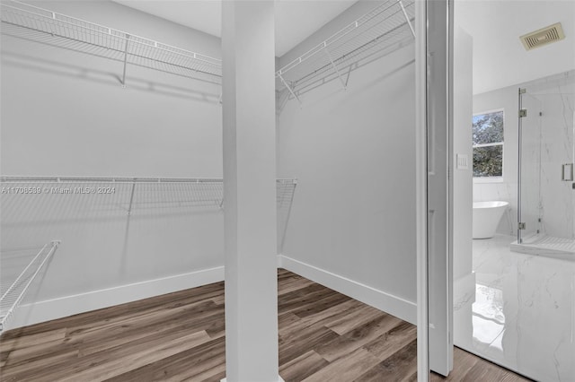 walk in closet featuring hardwood / wood-style floors