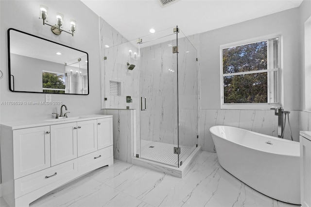 bathroom with vanity, separate shower and tub, and tile walls