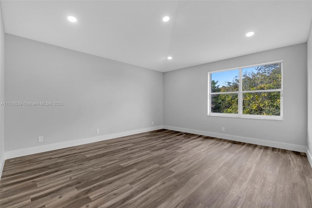 unfurnished room featuring hardwood / wood-style flooring