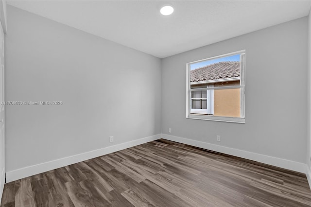 spare room featuring wood-type flooring