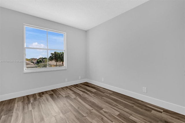 unfurnished room with hardwood / wood-style floors