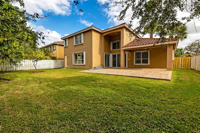 back of house featuring a yard and a patio