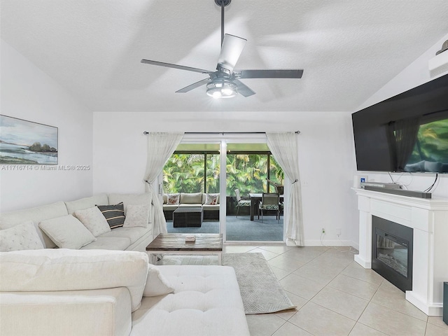 living room featuring light tile patterned floors, a textured ceiling, ceiling fan, and lofted ceiling