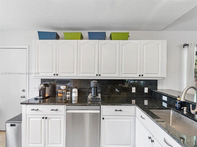 kitchen featuring white cabinetry, sink, and a textured ceiling