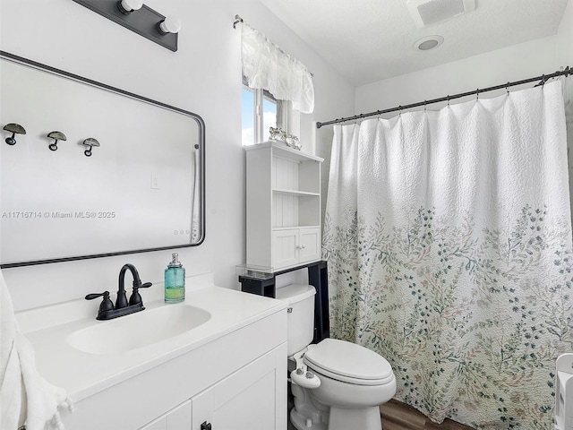 bathroom with vanity, toilet, a textured ceiling, curtained shower, and wood-type flooring