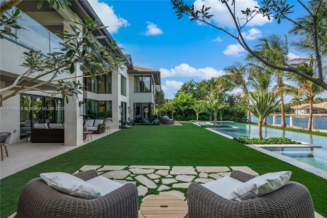 view of yard with an outdoor living space, a water view, a patio, and a balcony