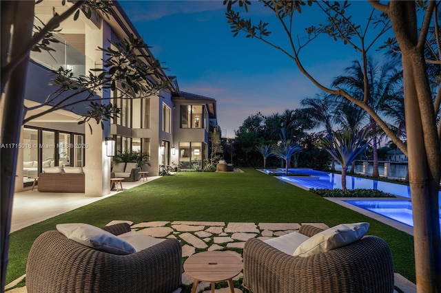 yard at dusk with a patio area