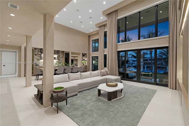 living room featuring a towering ceiling