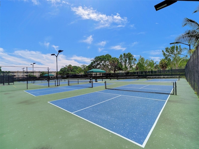 view of tennis court with basketball hoop