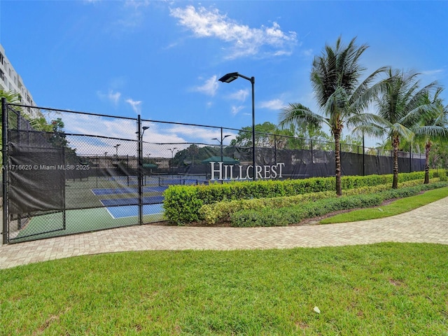 view of sport court with a yard