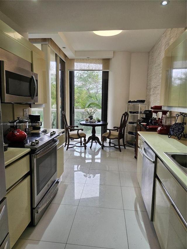 kitchen featuring light tile patterned floors and stainless steel appliances