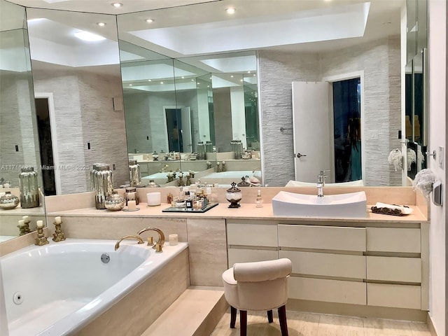 bathroom with tile patterned flooring, vanity, and a relaxing tiled tub