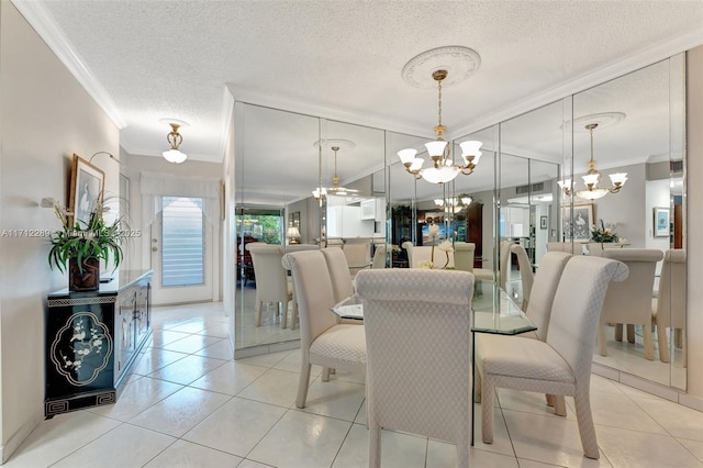 dining area featuring a textured ceiling, light tile patterned floors, crown molding, and an inviting chandelier