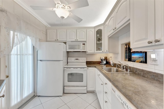 kitchen with white appliances, crown molding, sink, white cabinets, and light tile patterned flooring