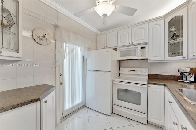 kitchen with white cabinetry, backsplash, white appliances, light tile patterned floors, and ornamental molding